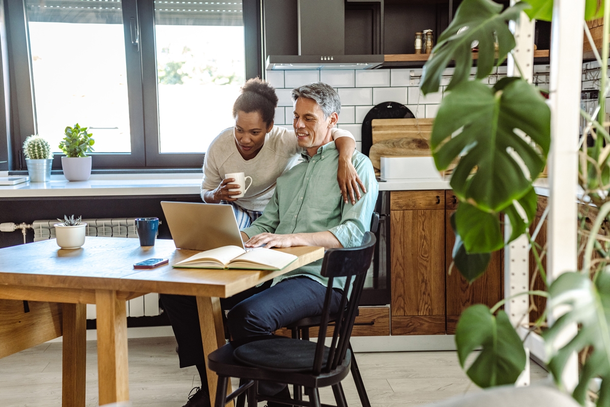 Couple looking at their laptop in the kitchen