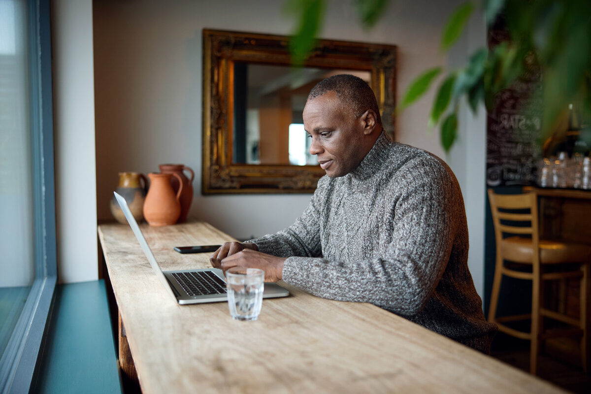 Man on his laptop in a cafe