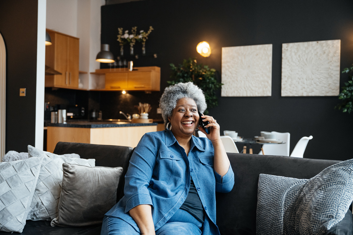 Women on the phone laughing at home