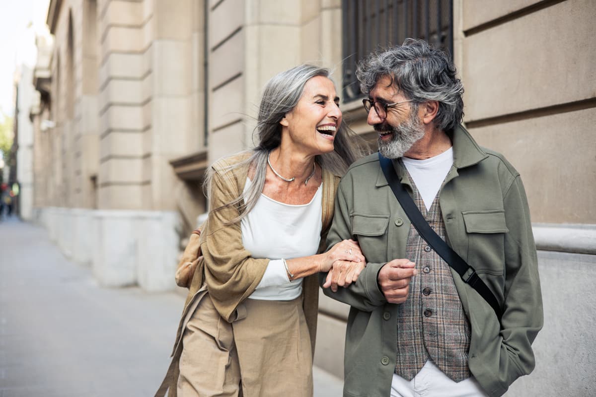 Man and women walking down the street laughing