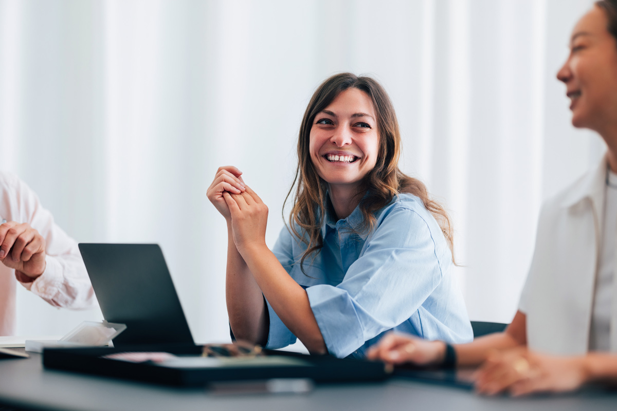 Female business women smiling in a meeting
