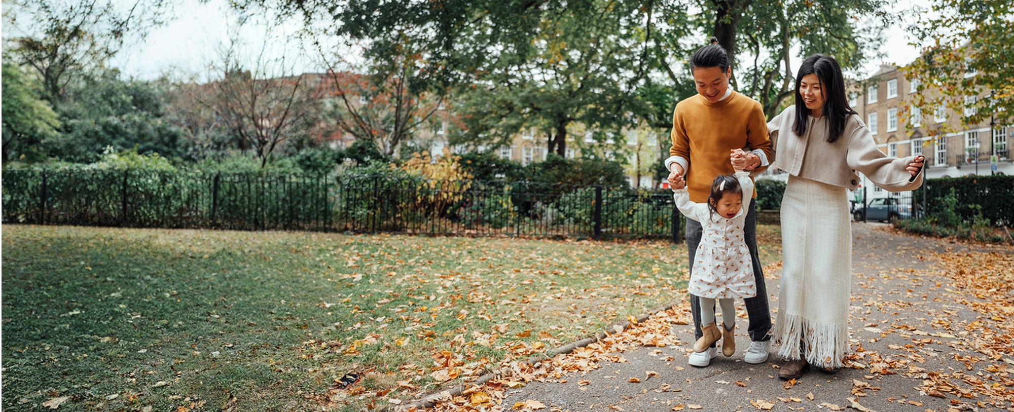 Mother, father and child walking through the park
