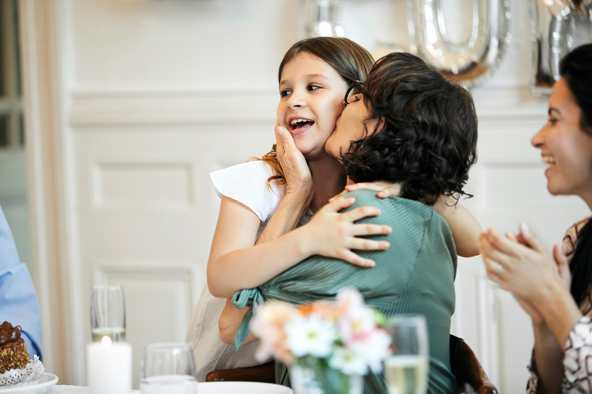 Mother kissing her young daughter on the cheek