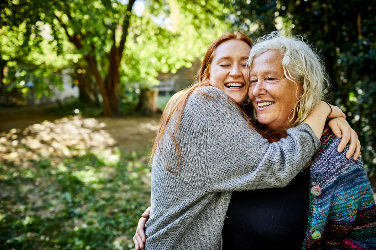 Two women hugging in the woods