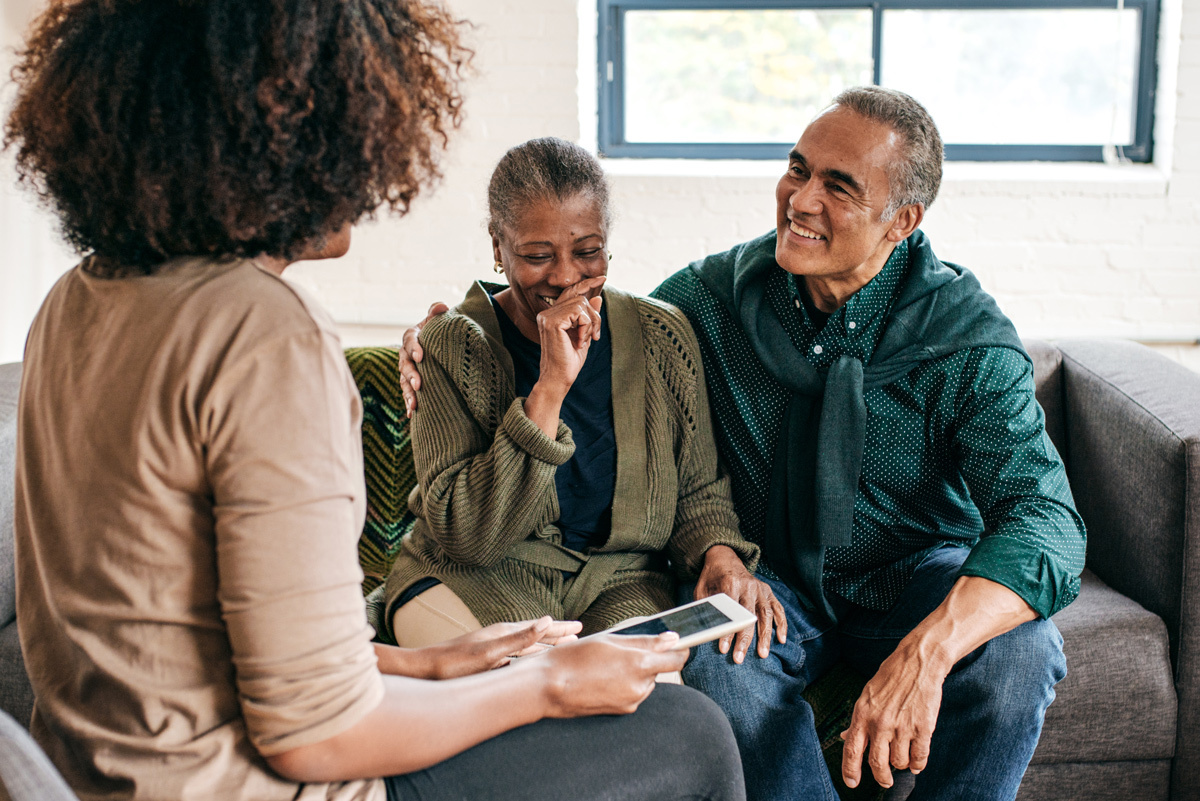 Couple laughing with their female adviser