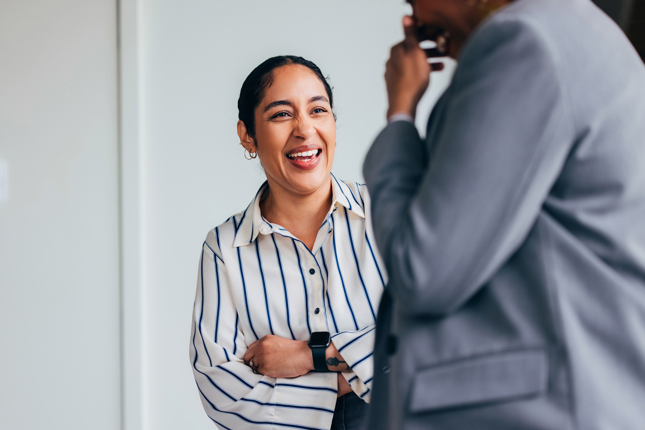 Female business women laughing with colleague