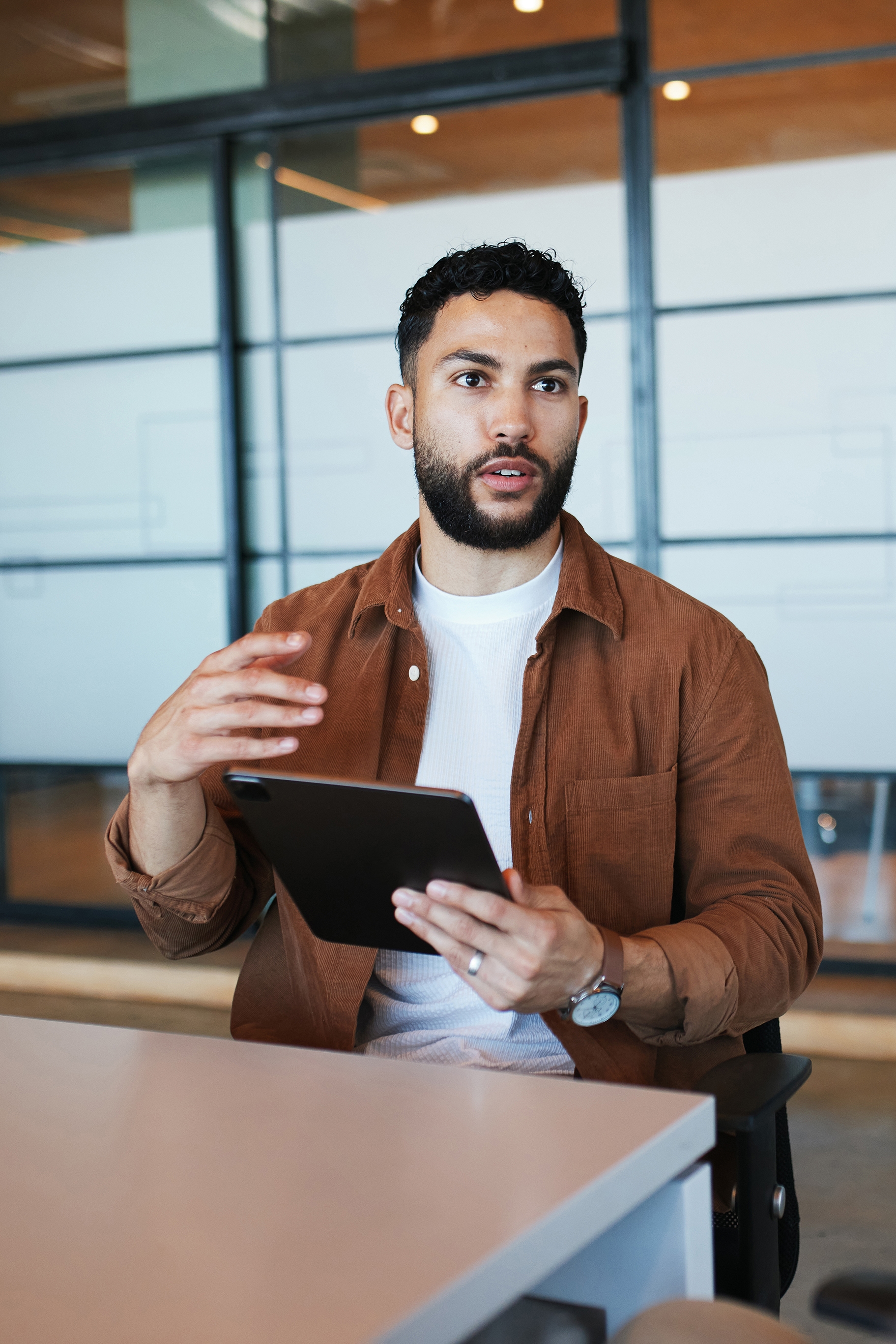 Man holding a tablet chatting