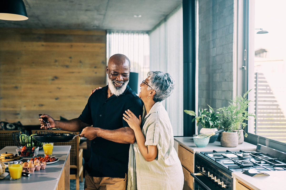 Man and women cooking together and laughing