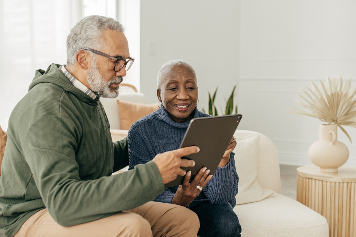 Man and women looking at a tablet