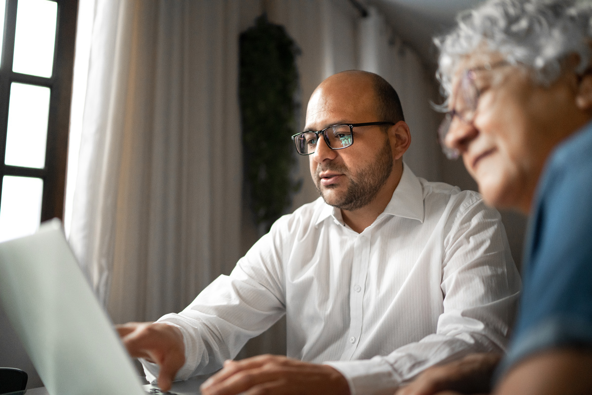 Two people looking at a laptop screen