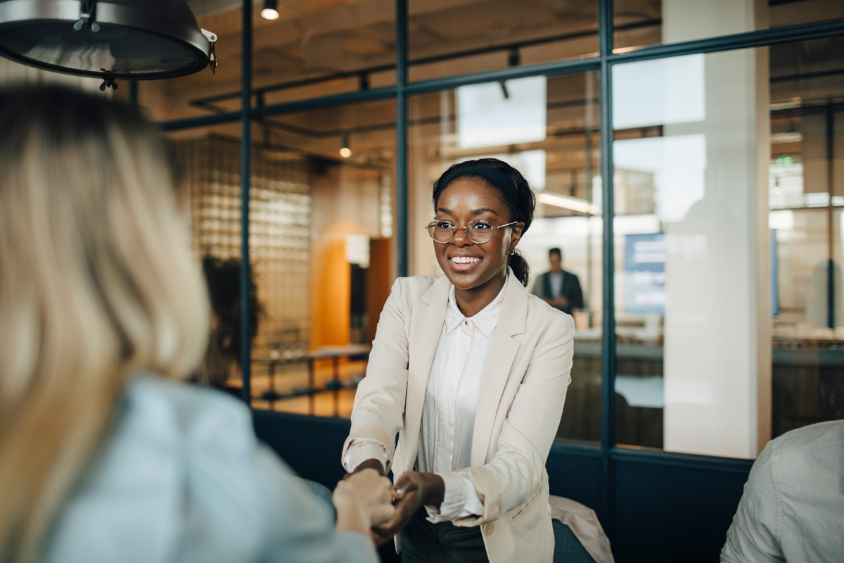 Two women shaking hands