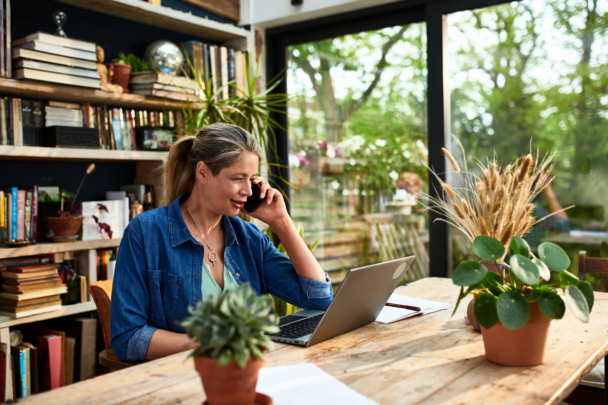 Women on the phone looking at her laptop