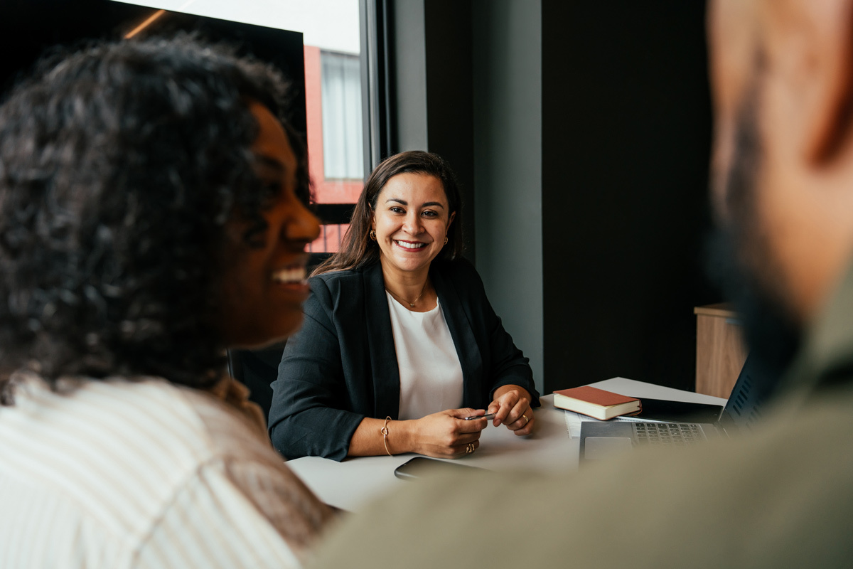 Women smiling sitting talking to a couple