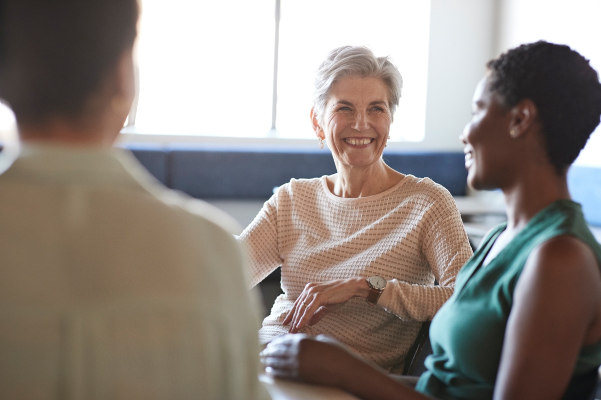 Happy female colleagues discussing in cafeteria